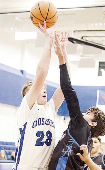 Corn Bible Academy’s Nathan Cooke shoots the ball over the Olustee-Eldorado defender during the Crusaders’ home win over the Diamondbacks. CDN | Sam Goodwyn
