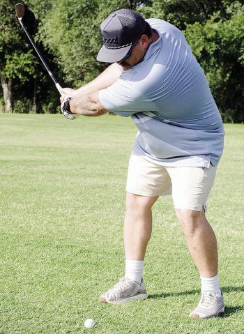 Austin Long raises his golf club as he prepares to hit the ball at Riverside Golf Course. CDN | Sam Goodwyn