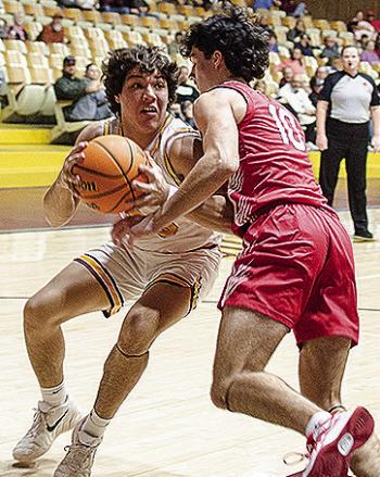 Clinton’s Easten Powell, left, drives through an Elgin defender during the Reds’ home win Tuesday against the Owls. CDN | Sam Goodwyn