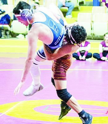 Clinton’s Tristan Cardenas, right, takes his opponent to the mat during the Reds’ match against Marlow Thursday in the Tornado dome. CDN | Sam Goodwyn