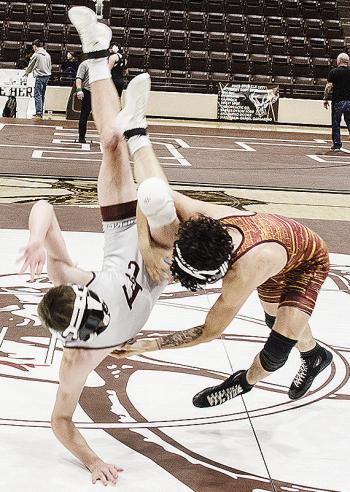 Clinton’s Tristan Cardenas, right, throws his opponent to the mat during the District Duals in Elk City. CDN | Sam Goodwyn