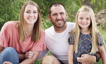 New Clinton Defensive Coordinator Skylar Watson, center, smiles with his wife Jannie, left, and daughter Journey, right. CDN | Courtesy photo