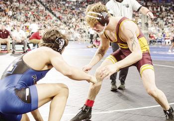Clinton’s Landon Wilson, right, eyes an opening against his opponent from Harrah in Class 4A 165-pound weight class championship match Saturday at OG&amp;E Coliseum in Oklahoma City. CDN | Sam Goodwyn