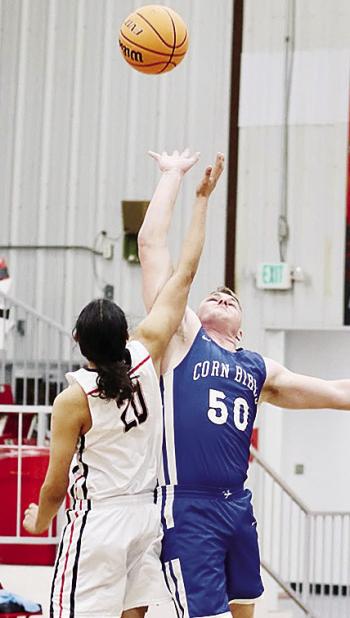 Corn Bible Academy’s Cruz Bittle, right, jumps for the tip to start a game this season on the road. CDN | Courtesy photo