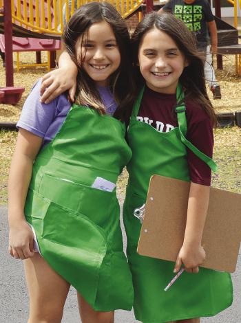 Camila Murphy, left, and Journey Patton were out at recess taking coffee orders while dressed as baristas Monday at Southwest Elementary. CDN | Christian Jacobsen